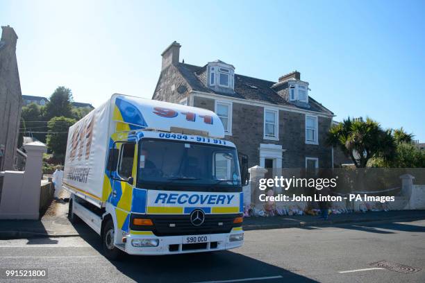 Recovery vehicle arrives to remove a Dacia car, as police are searching a house in Ardbeg Road on the Isle of Bute in Scotland, after the body of...