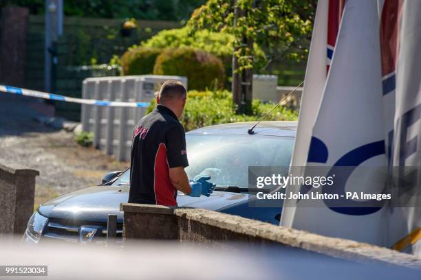 Recovery vehicle arrives to remove a Dacia car, as police are searching a house in Ardbeg Road on the Isle of Bute in Scotland, after the body of...