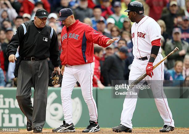 Manager Terry Francona of the Boston Red Sox tries to keep his player David Ortiz away from home plate umpire Dale Scott after Ortiz was called for a...