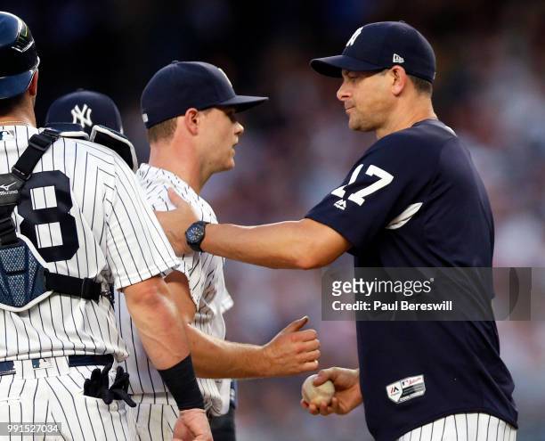 Manager Aaron Boone of the New York Yankees takes the ball from pitcher Sonny Gray as he removes Gray the game in the third inning of an MLB baseball...