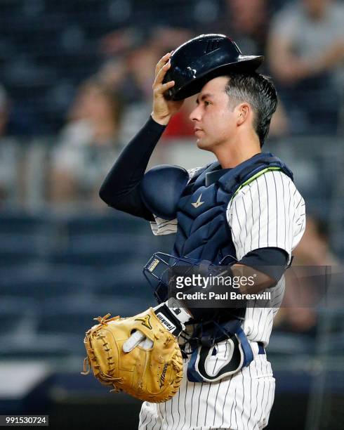 Kyle Higashioka of the New York Yankees gets ready to catch in an MLB baseball game against the Boston Red Sox on June 30, 2018 at Yankee Stadium in...