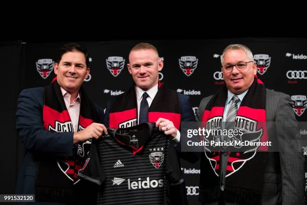 United Managing Partner and CEO Jason Levien, Wayne Rooney of DC United, and DC United General Manager Dave Kasper pose with a jersey during his...