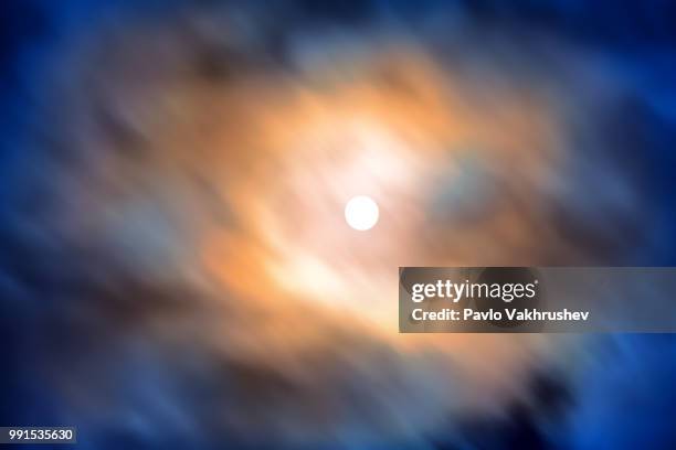 night view at the full moon through moving blue clouds - blue moon stock pictures, royalty-free photos & images