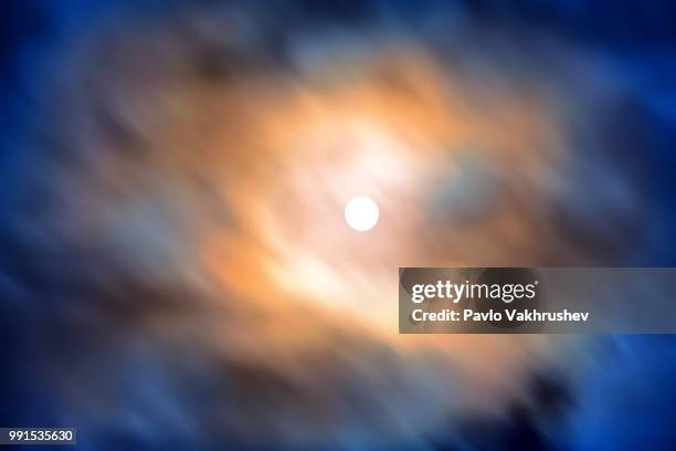 night view at the full moon through moving blue clouds - blue moon imagens e fotografias de stock