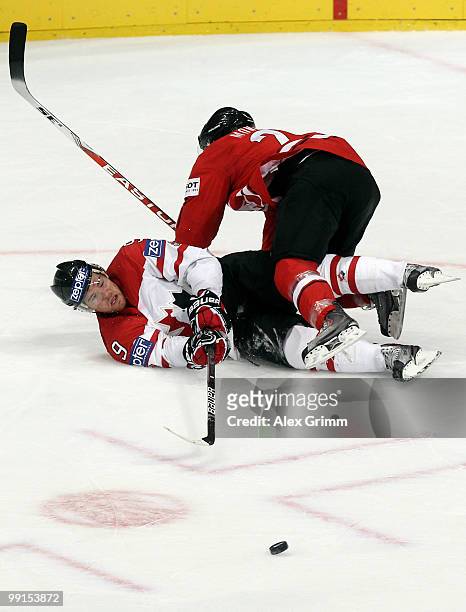 Steve Downie of Canada passes the puck against Thibaut Monnet of Switzerland during the IIHF World Championship group C match between Canada and...