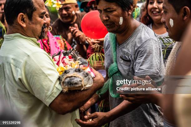 June 2018, Mexico, San Pedro Huamelula: Victor Aguilar Ricardez , Mayor of San Pedro Huamelula, gives one of the village men the "Crocodile bride"....