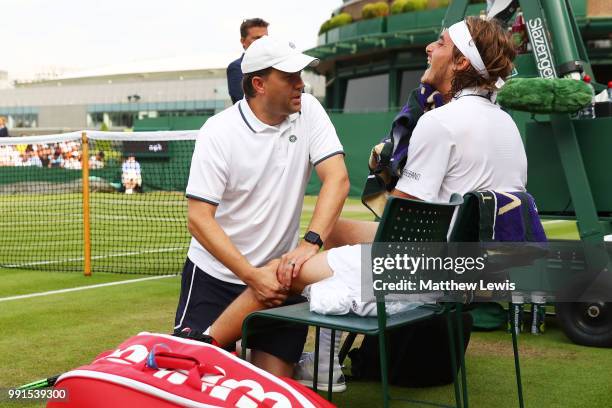 Stefanos Tsitsipas of Greece is treated for an injury during his Men's Singles second round match against Jared Donaldson of the United States on day...