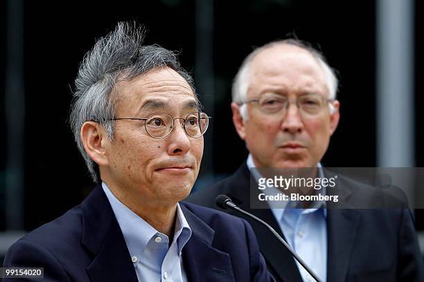 Ken Salazar, U.S. Interior secretary, right, looks on as Steven Chu, U.S. Energy secretary, speaks to members of the media after meeting with workers...