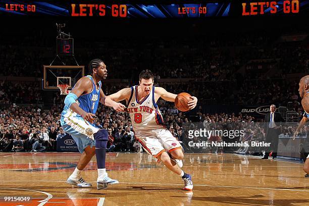 Danilo Gallinari of the New York Knicks drives to the basket against Nene of the Denver Nuggets during the game at Madison Square Garden on March 23,...