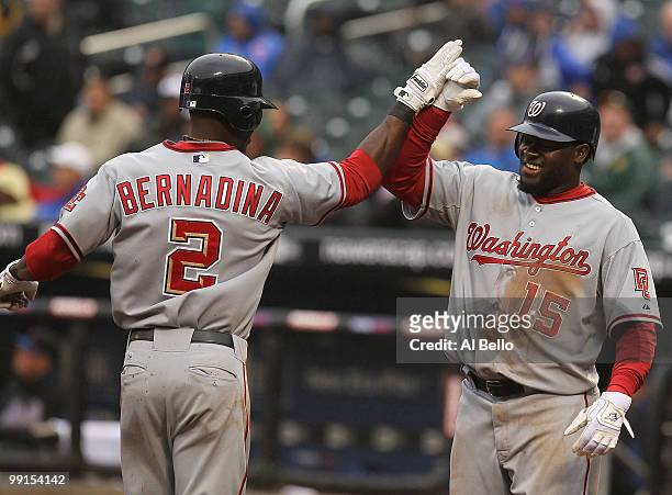 Roger Bernadina of the Washington Nationals is met by Cristian Guzman after hitting his 9th inning go ahead home run against the New York Mets during...