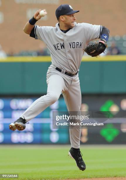 Derek Jeter of the New York Yankees makes a leaping throw to first base in the 3rd inning of the first game of a double header against the Detroit...