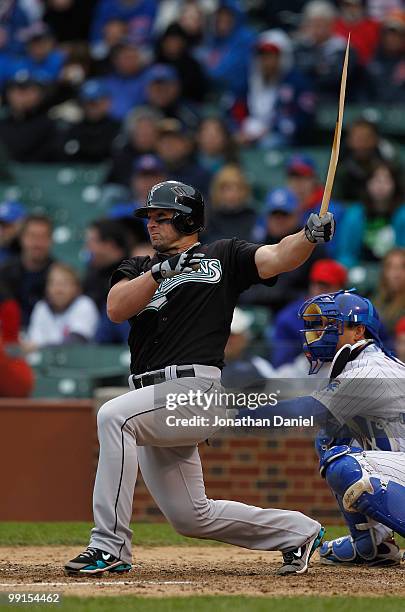 Dan Uggla of the Florida Marlins is left with a broken bat after a hit in the 8th inning against the Chicago Cubs at Wrigley Field on May 12, 2010 in...