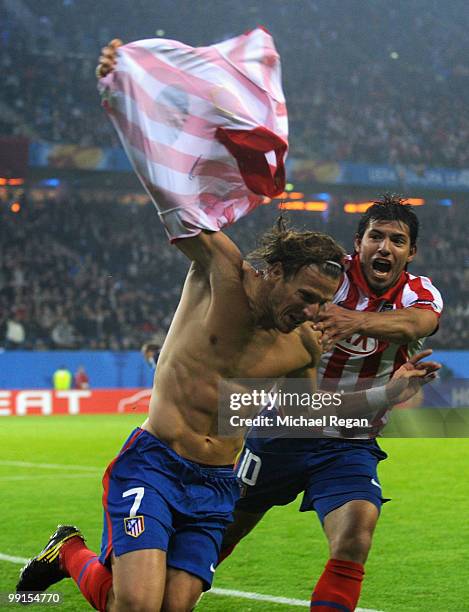 Diego Forlan of Atletico Madrid celebrates with his team mate Sergio Aguero after scoring his team's second goal during the UEFA Europa League final...