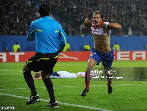 Diego Forlan of Atletico Madrid celebrates after scoring his team's second goal in extra time during the UEFA Europa League final match between...