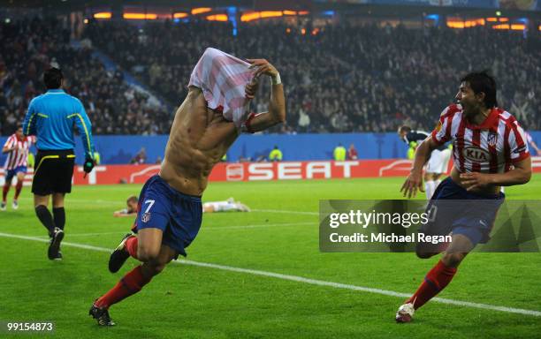 Diego Forlan of Atletico Madrid celebrates with team mate Sergio Aguero after scoring his team's second and winning goal in extra time during the...