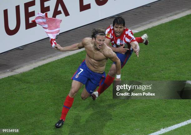 Diego Forlan of Atletico Madrid celebrates with team mate Sergio Aguero after scoring his team's second and winning goal in extra time during the...