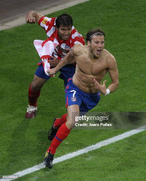 Diego Forlan of Atletico Madrid celebrates with team mate Sergio Aguero after scoring his team's second and winning goal in extra time during the...