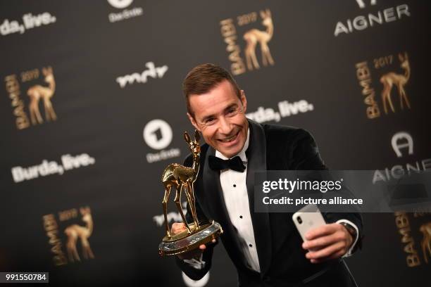 Moderator Kai Pflaume showing his Bambi, which he won in the "Audience Bambi: Moderation" category, in Berlin, Germany, 16 November 2017. The Hubert...