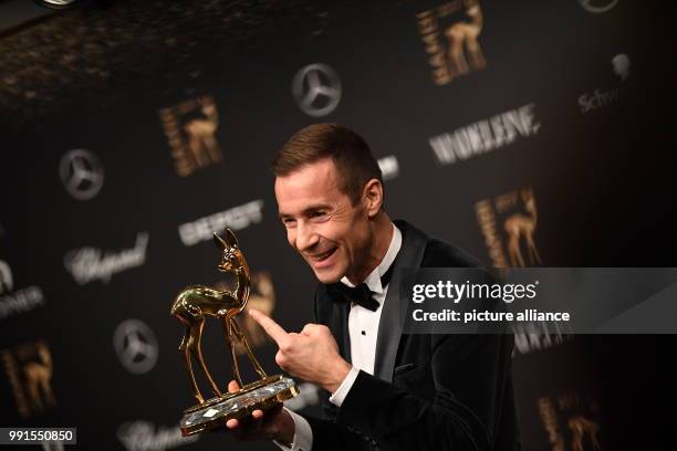 Moderator Kai Pflaume showing his Bambi, which he won in the "Audience Bambi: Moderation" category, in Berlin, Germany, 16 November 2017. The Hubert...
