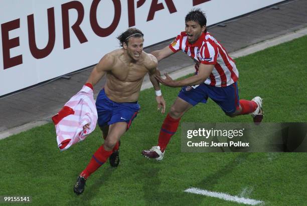 Diego Forlan of Atletico Madrid celebrates with team mate Sergio Aguero after scoring his team's second and winning goal in extra time during the...