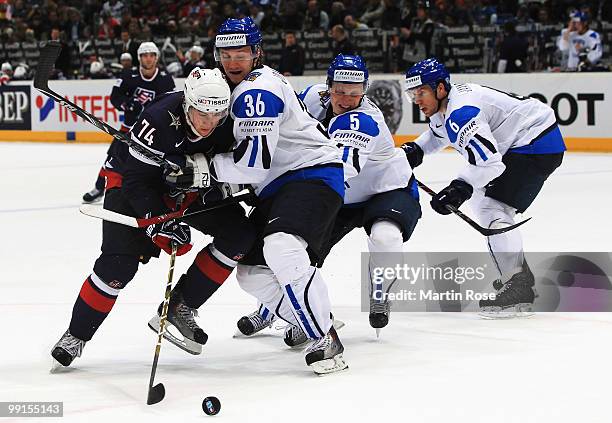 Jussi Jokinen of Finland and TJ Oshie of USA battle for the puck during the IIHF World Championship group A match between Finland and USA at Lanxess...