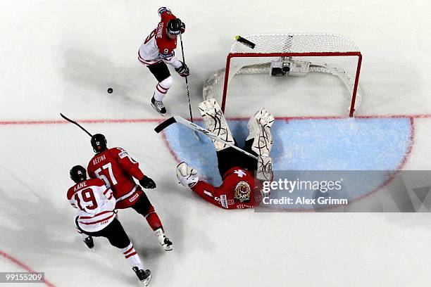 Goalkeeper Tobias Stephan of Switzerland makes a save against Steve Downie of Canada during the IIHF World Championship group C match between Canada...