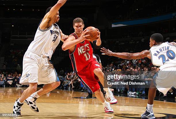 Brook Lopez of the New Jersey Nets drives the ball against JaVale McGee of the Washington Wizards during the game at the Verizon Center on April 4,...