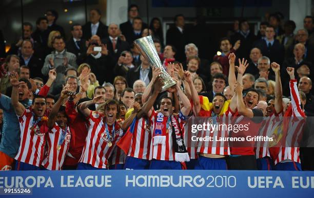 Atletico Madrid players celebrate with the UEFA Europa League trophy after extra time following their victory at the end of the UEFA Europa League...