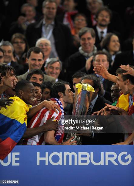 Antonio Lopez of Atletico Madrid kisses the UEFA Europa League trophy after extra time following their victory at the end of the UEFA Europa League...
