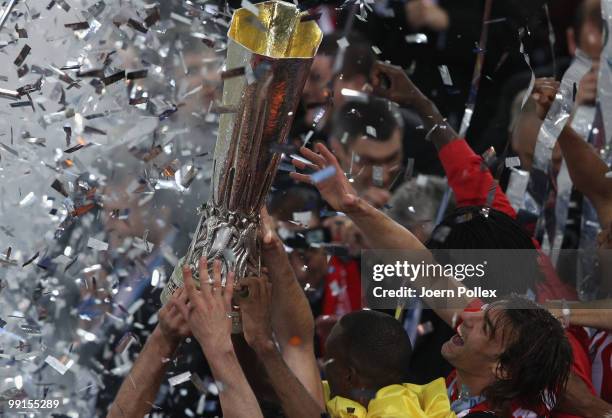 Atletico Madrid players hold the UEFA Europa League trophy following his team's victory after extra time at the end of the UEFA Europa League final...