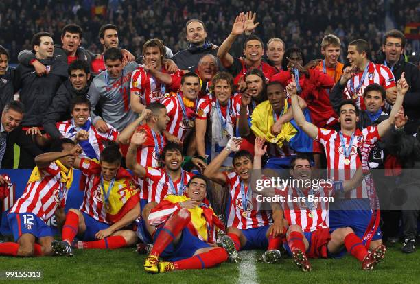 Atletico Madrid players celebrate with the UEFA Europa League trophy after extra time following their victory at the end of the UEFA Europa League...