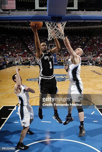 Malik Hairston of the San Antonio Spurs puts a shot up against Marcin Gortat of the Orlando Magic during the game at Amway Arena on March 17, 2010 in...