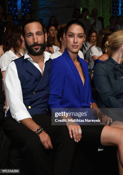 Massimo Sinato and Rebecca Mir attend the Riani show during the Berlin Fashion Week Spring/Summer 2019 at ewerk on July 4, 2018 in Berlin, Germany.