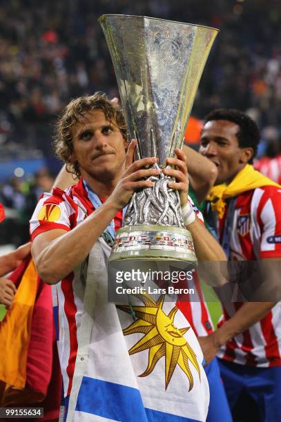 Diego Forlan of Atletico Madrid holds the UEFA Europa League trophy following his team's victory after extra time at the end of the UEFA Europa...