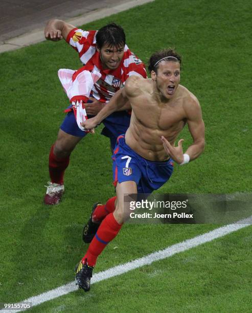 Diego Forlan of Atletico Madrid celebrates with team mate Sergio Aguero after scoring his team's second and winning goal in extra time during the...