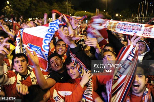 Thousands of Atletico Madrid supporters jubilate at the Neptune fountain in the center of Madrid on May 12, 2010 after Atetico Madrid won the final...