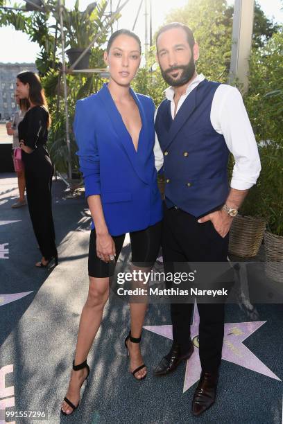 Rebecca Mir and Massimo Sinato attend the Riani show during the Berlin Fashion Week Spring/Summer 2019 at ewerk on July 4, 2018 in Berlin, Germany.