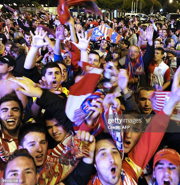 Thousands of Atletico Madrid supporters jubilate at the Neptune fountain in the center of Madrid on May 12, 2010 after Atetico Madrid won the final...
