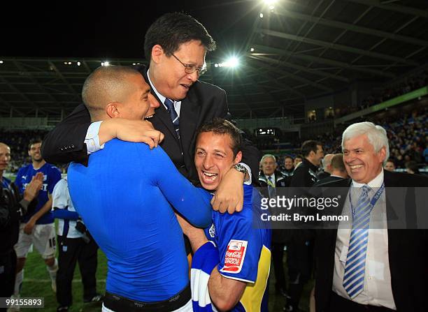 Cardiff City Director Dato Chan Tien Ghee celebrates with players Michael Chopra and Jay Bothroyd as Peter Ridsdale looks on after they won the...