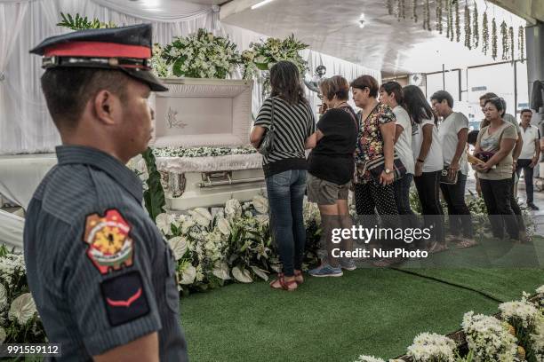 Mourners view the remains of General Tinio Mayor Ferdinand Bote, who was assassinated by unidentified gunmen on motorcycles, during his funeral wake...