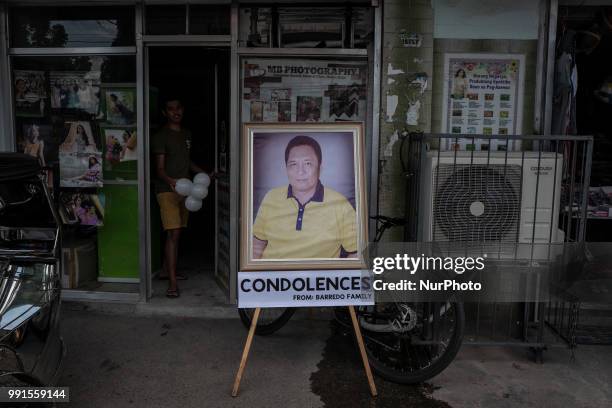 Portrait of General Tinio Mayor Ferdinand Bote, who was assassinated by unidentified gunmen on motorcycles, is seen outside a store in General Tinio...