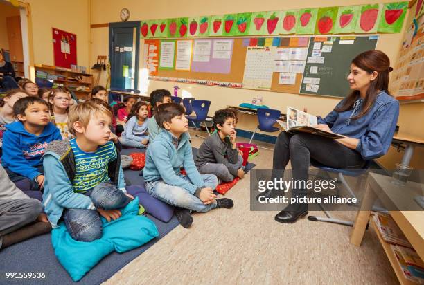 The news anchor and journalist Linda Zervakis reads aloud to pupils of the 2c class and their teacher from the book "Armstrong: the adventurous...
