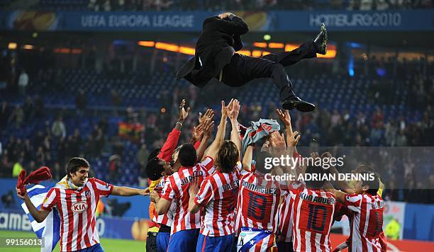 Aletico Madrid's players throw their coach Quique Sanchez Flores in the air after winning the final football match of the UEFA Europa League Fulham...