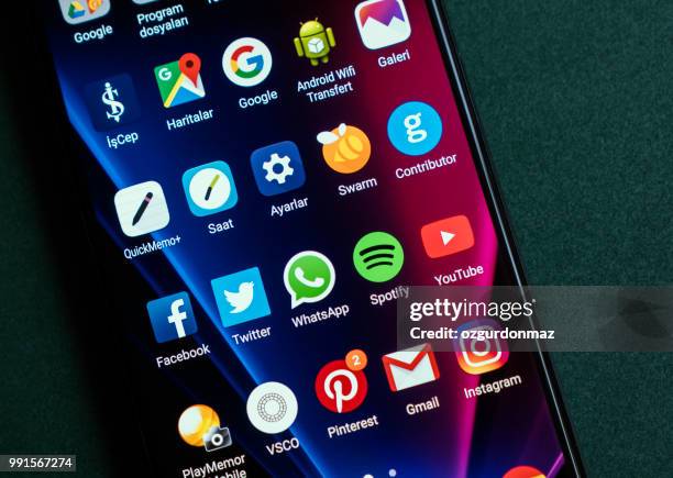 black colored lg v30 plus smartphone in hand - ozgurdonmaz stock pictures, royalty-free photos & images
