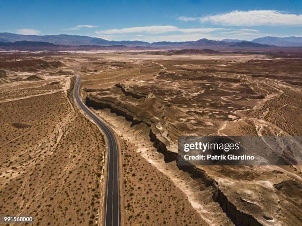 arial view of empty road in the desert - arial desert stock-fotos und bilder