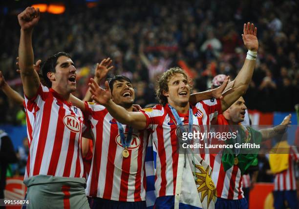 Diego Forlan , Sergio Aguero and Raul Garcia of Atletico Madrid celebrates their victory after extra time at the end of the UEFA Europa League final...