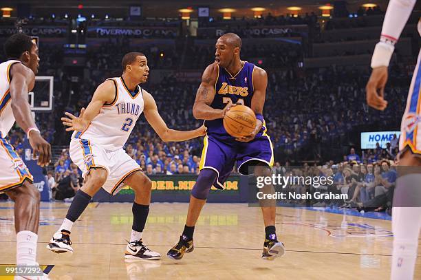 Kobe Bryant of the Los Angeles Lakers looks to move the ball around Thabo Sefolosha of the Oklahoma City Thunder in Game Six of the Western...