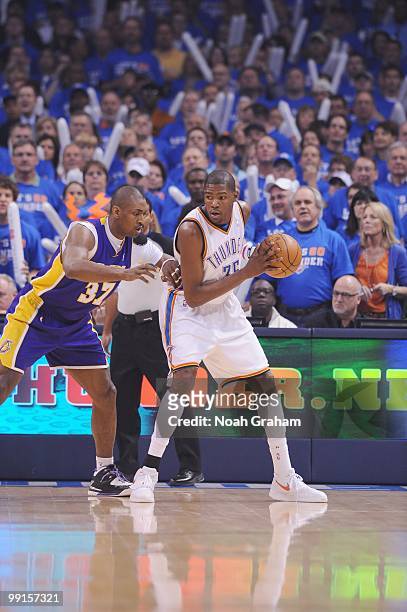 Kevin Durant of the Oklahoma City Thunder looks to move the ball around Ron Artest of the Los Angeles Lakers in Game Six of the Western Conference...