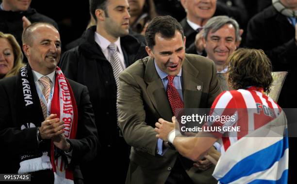 Spain's Prince Felipe congratulates Atletico Madrid's Uruguayan forward Diego Forlan after the final football match of the UEFA Europa League Fulham...