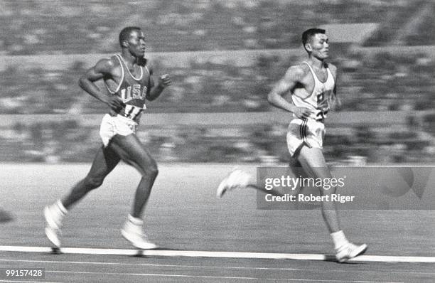 Rafer Johnson of the United States competes against Yang Chuan-kwang of China in the 1500 Metres portion of the Decathlon competition during the 1960...